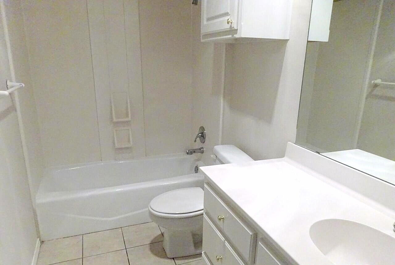 10108 Evanston Avenue, Unit 2 Lubbock, TX 79424 - Photo 8 of 8 a bathroom with a sink a toilet and bathtub