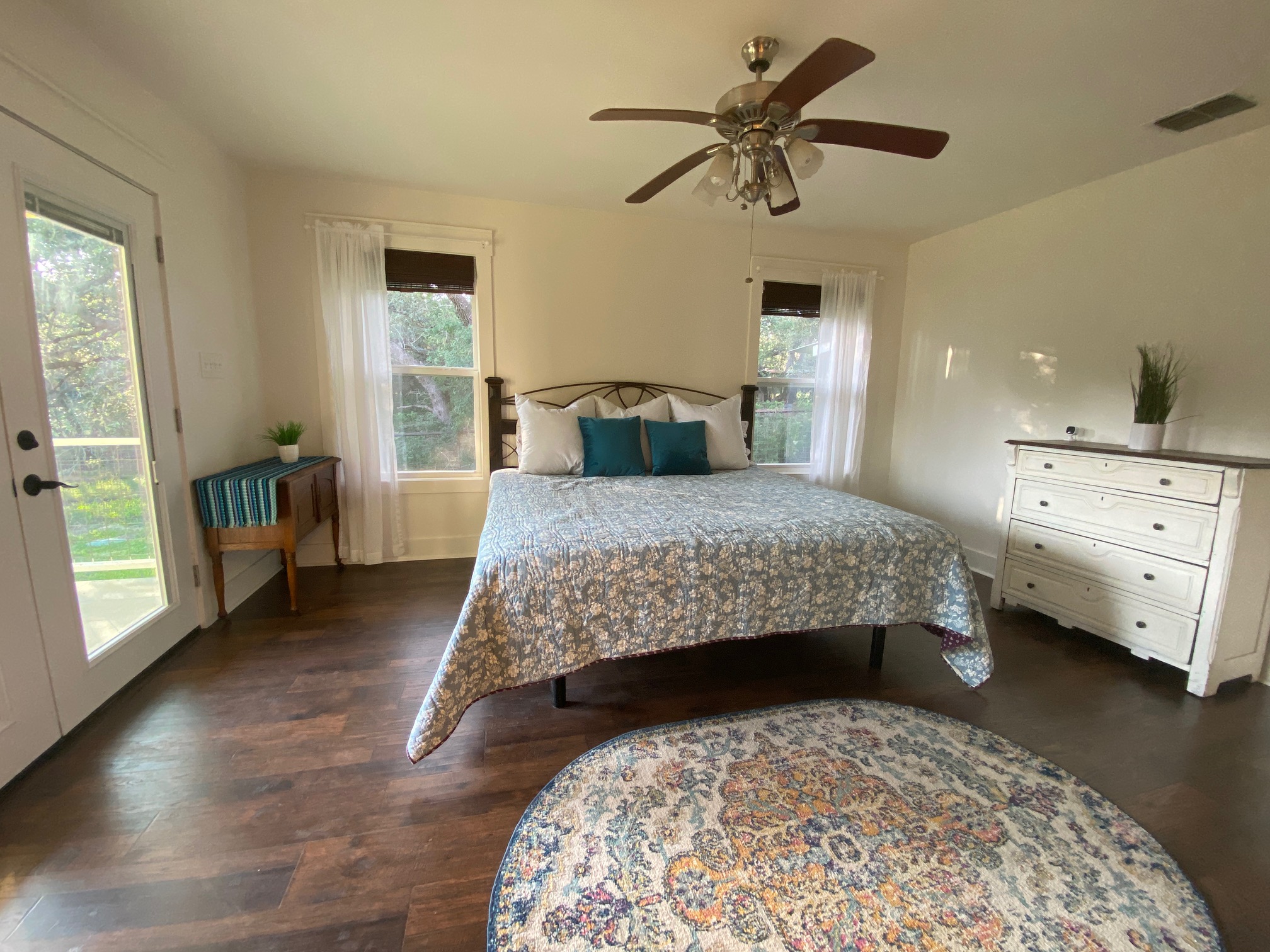 306 Plainview Road Wimberley, TX 78676 - Photo 10 of 29 Beautiful flooring complement this cozy bedroom with a walk-out door to the outside.