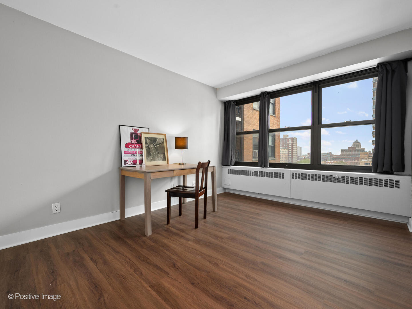 6118 North Sheridan Road, Unit 1003 Chicago, IL 60660 - Photo 12 of 13 a view of a room with wooden floor and windows