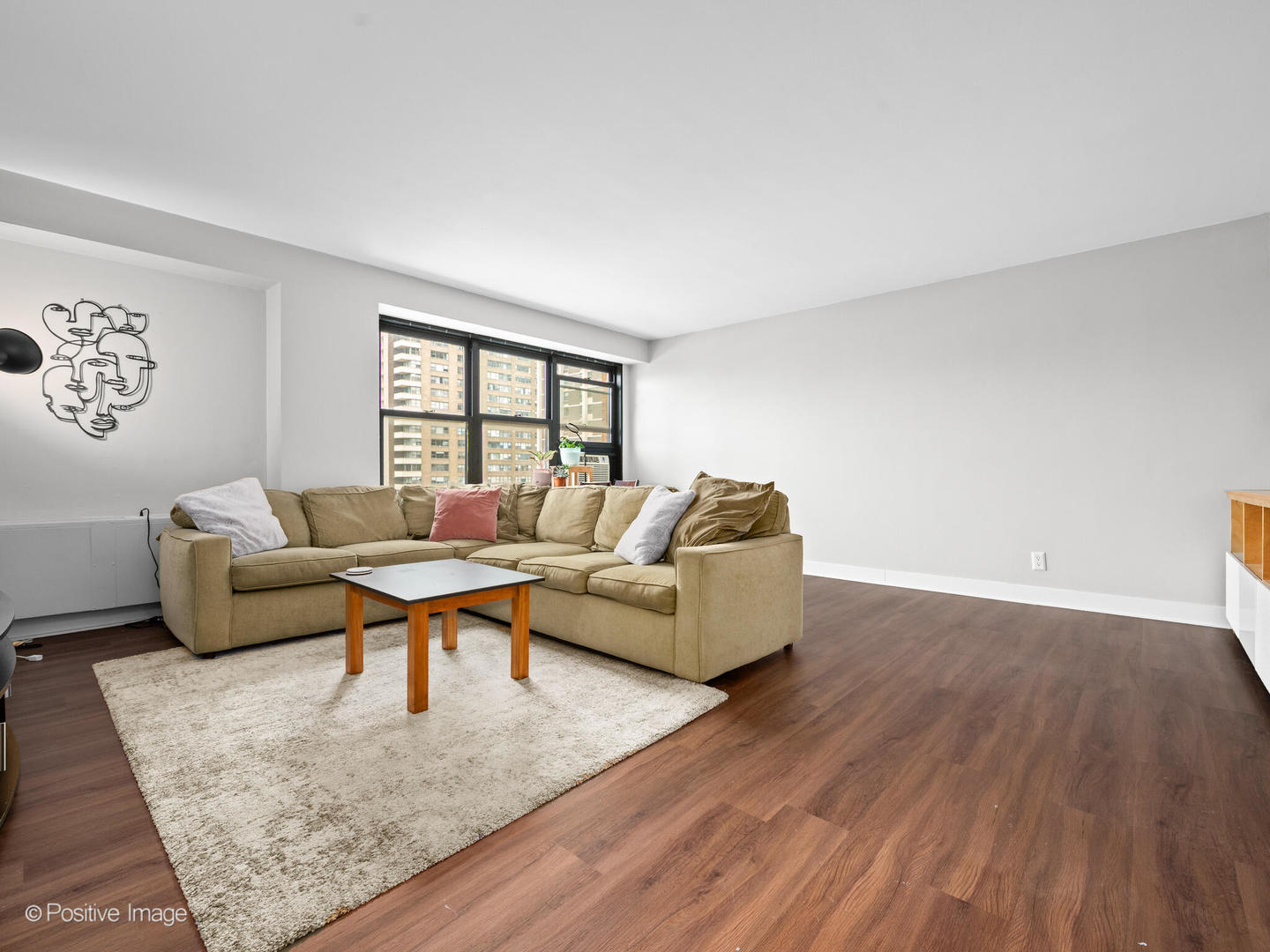 6118 North Sheridan Road, Unit 1003 Chicago, IL 60660 - Photo 2 of 13 a living room with furniture and a rug