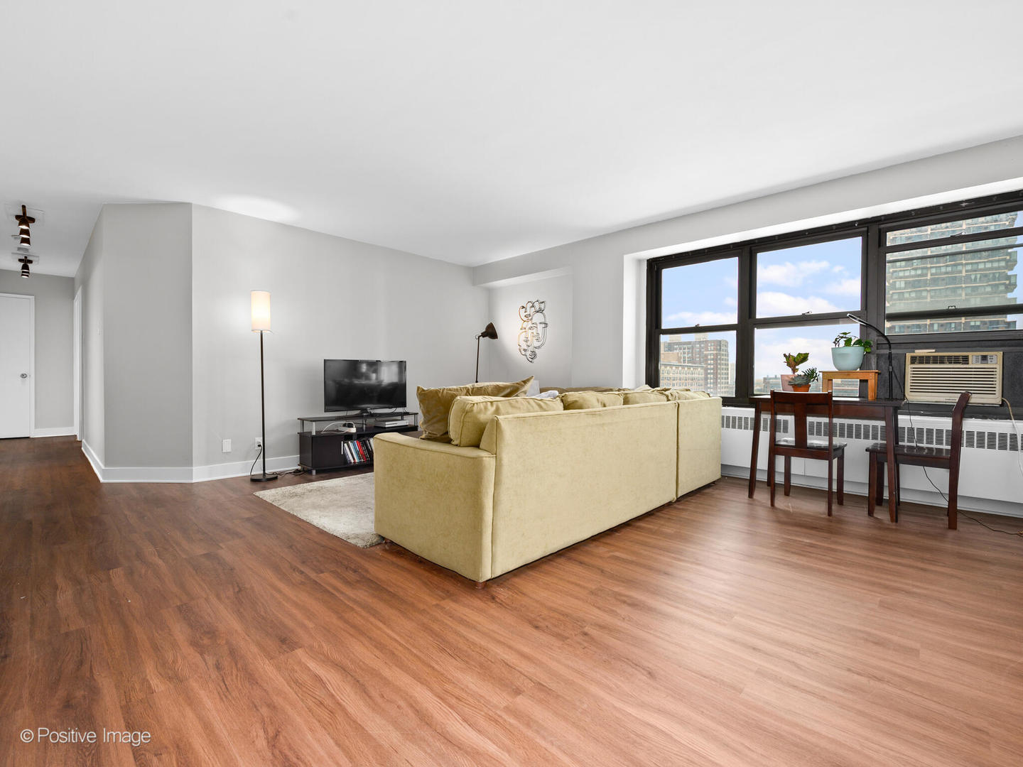6118 North Sheridan Road, Unit 1003 Chicago, IL 60660 - Photo 5 of 13 a living room with furniture and a large window