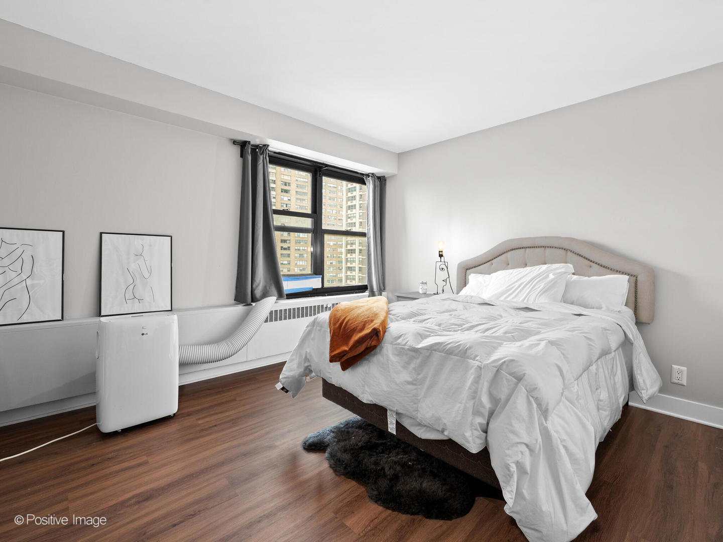 6118 North Sheridan Road, Unit 1003 Chicago, IL 60660 - Photo 10 of 13 a bedroom with a bed and a large window