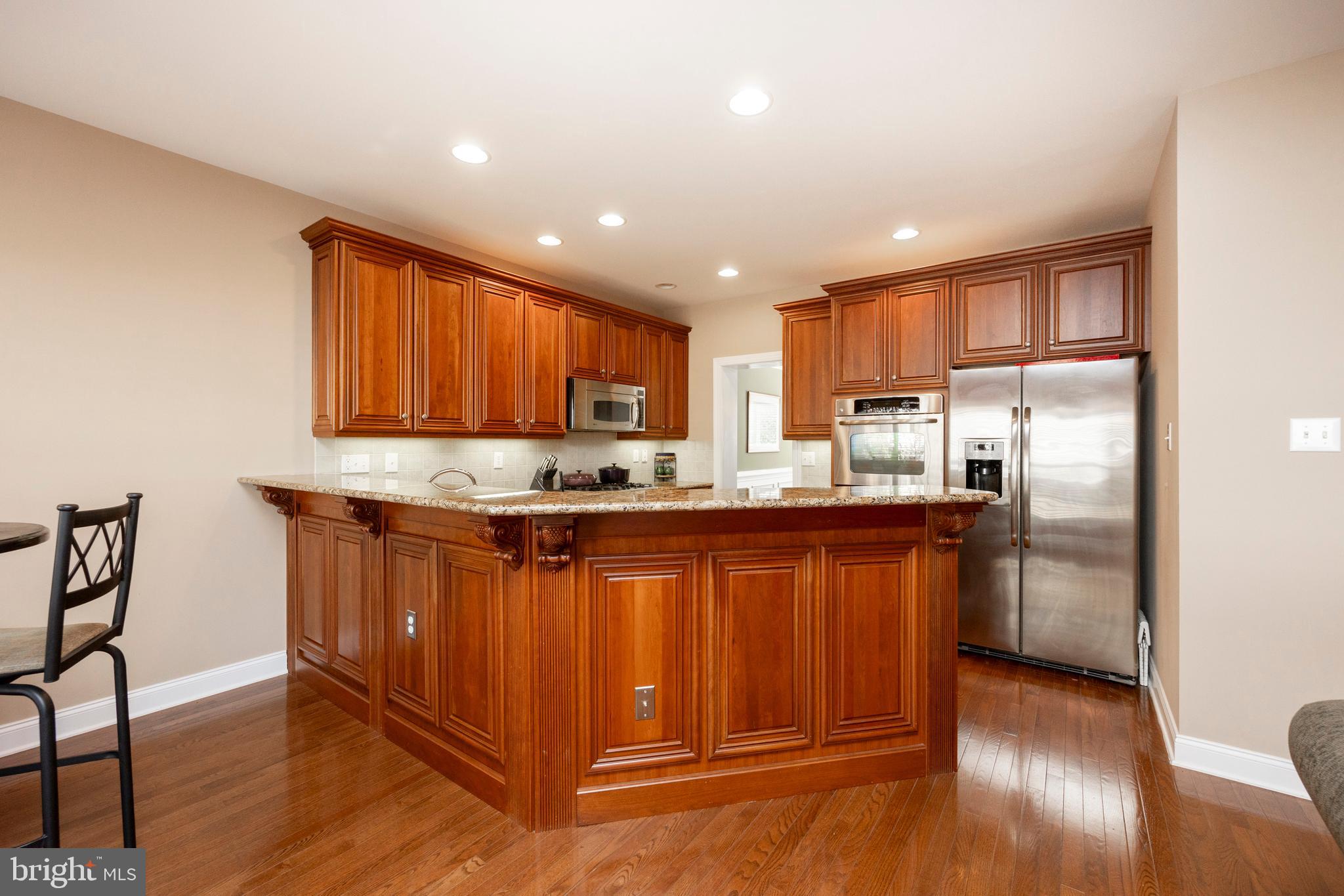 29 Ashtree Lane Malvern, PA 19355 - Photo 15 of 39 a kitchen with stainless steel appliances granite countertop wooden cabinets a refrigerator and a sink