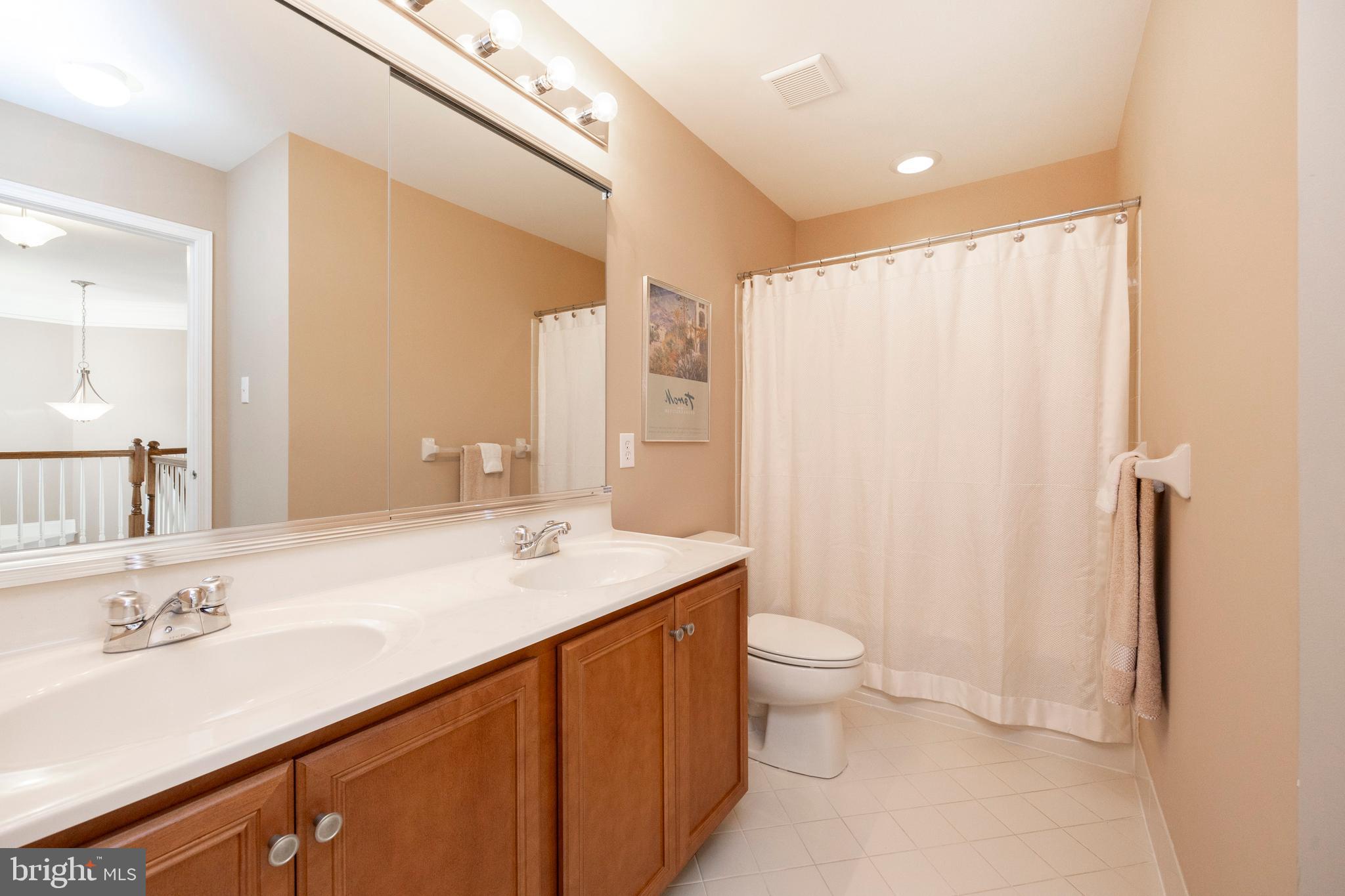 29 Ashtree Lane Malvern, PA 19355 - Photo 23 of 39 a bathroom with a granite countertop sink a toilet a mirror and shower