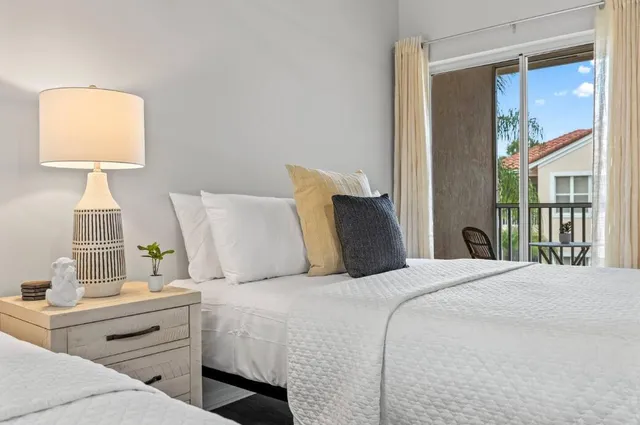 a bedroom with a bed and a lamp on table