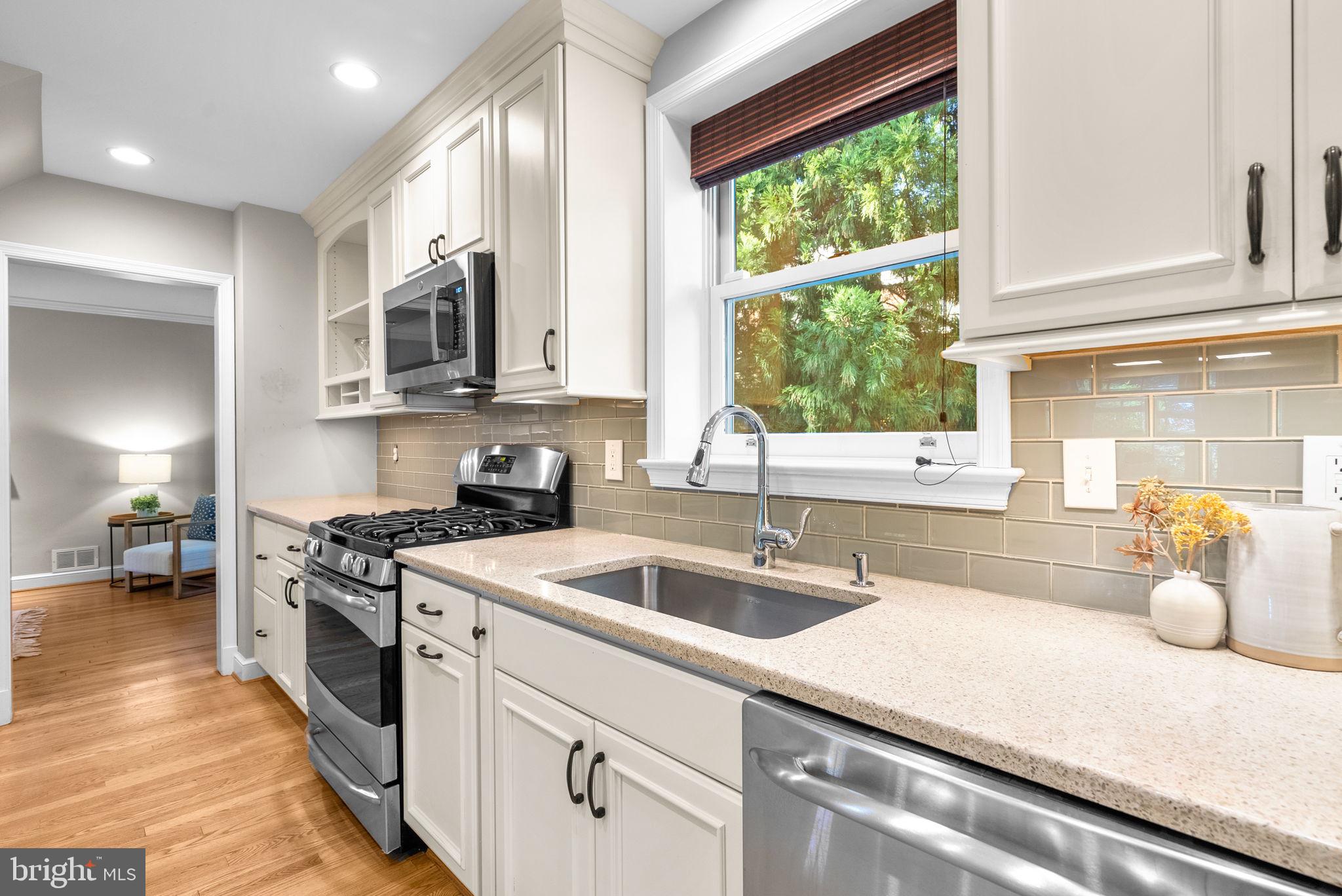129 Lynnmoor Drive Silver Spring, MD 20901 - Photo 15 of 48 a kitchen with stainless steel appliances granite countertop a sink a stove and a wooden cabinets