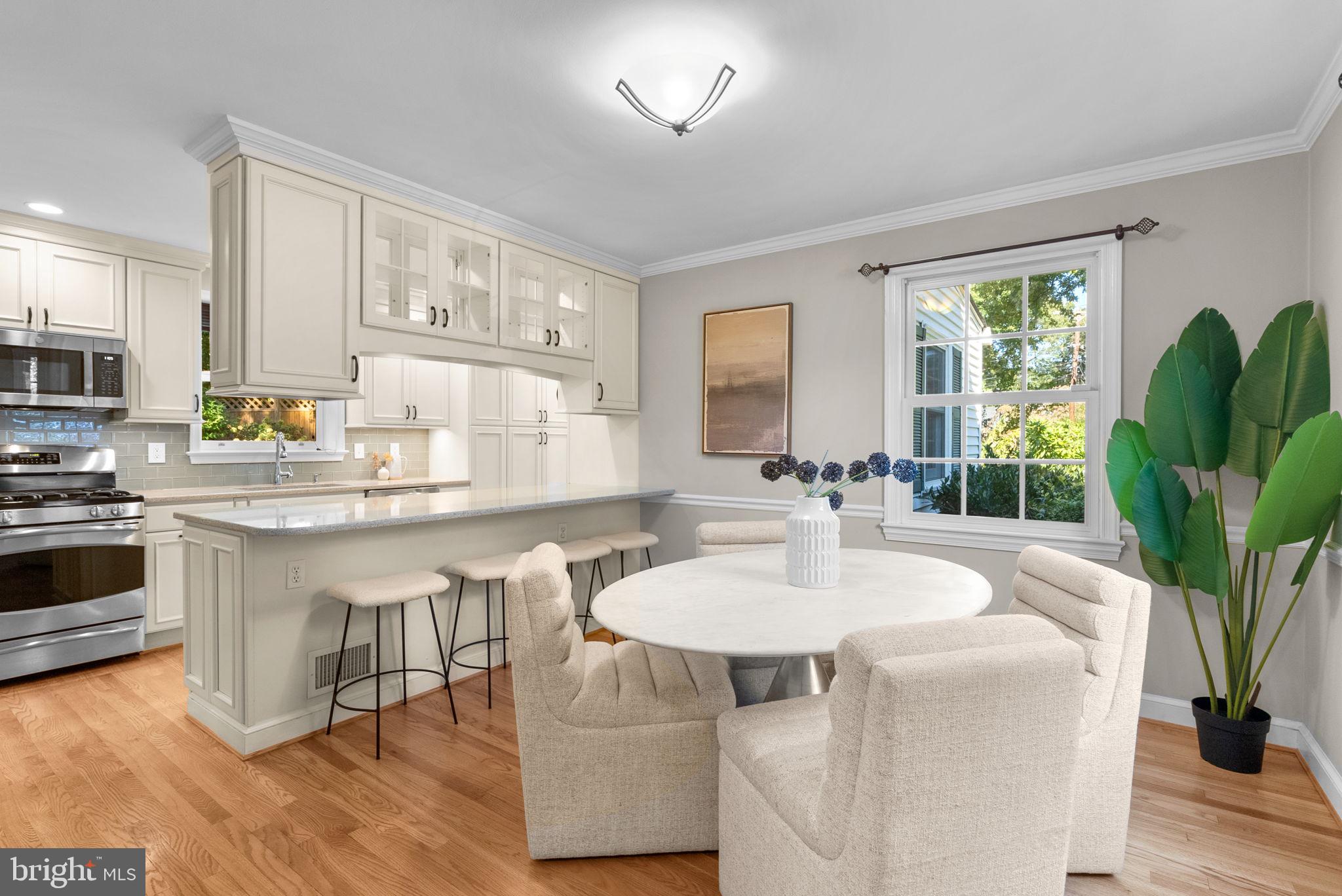 129 Lynnmoor Drive Silver Spring, MD 20901 - Photo 18 of 48 a kitchen with a table chairs stove and white cabinets