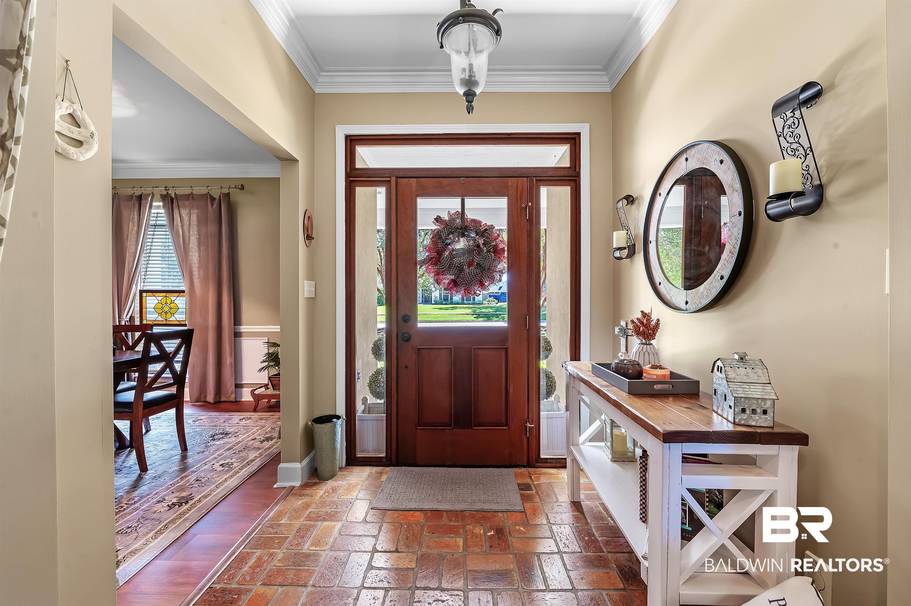 9901 Glover Court Fairhope, AL 36532 - Photo 2 of 52 Foyer entrance featuring ornamental molding and a healthy amount of sunlight