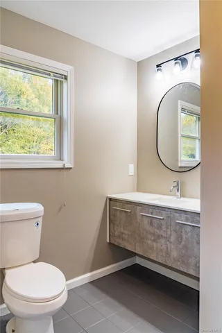 a bathroom with a toilet a sink and a mirror