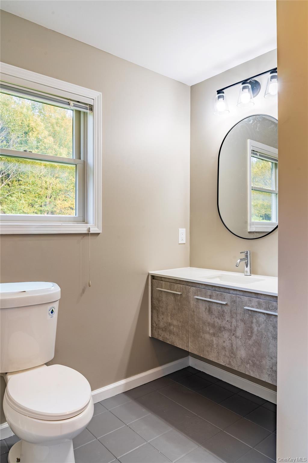 376 Wade Road Liberty, NY 12754 - Photo 15 of 26 Bathroom featuring dark tile patterned floors and vanity