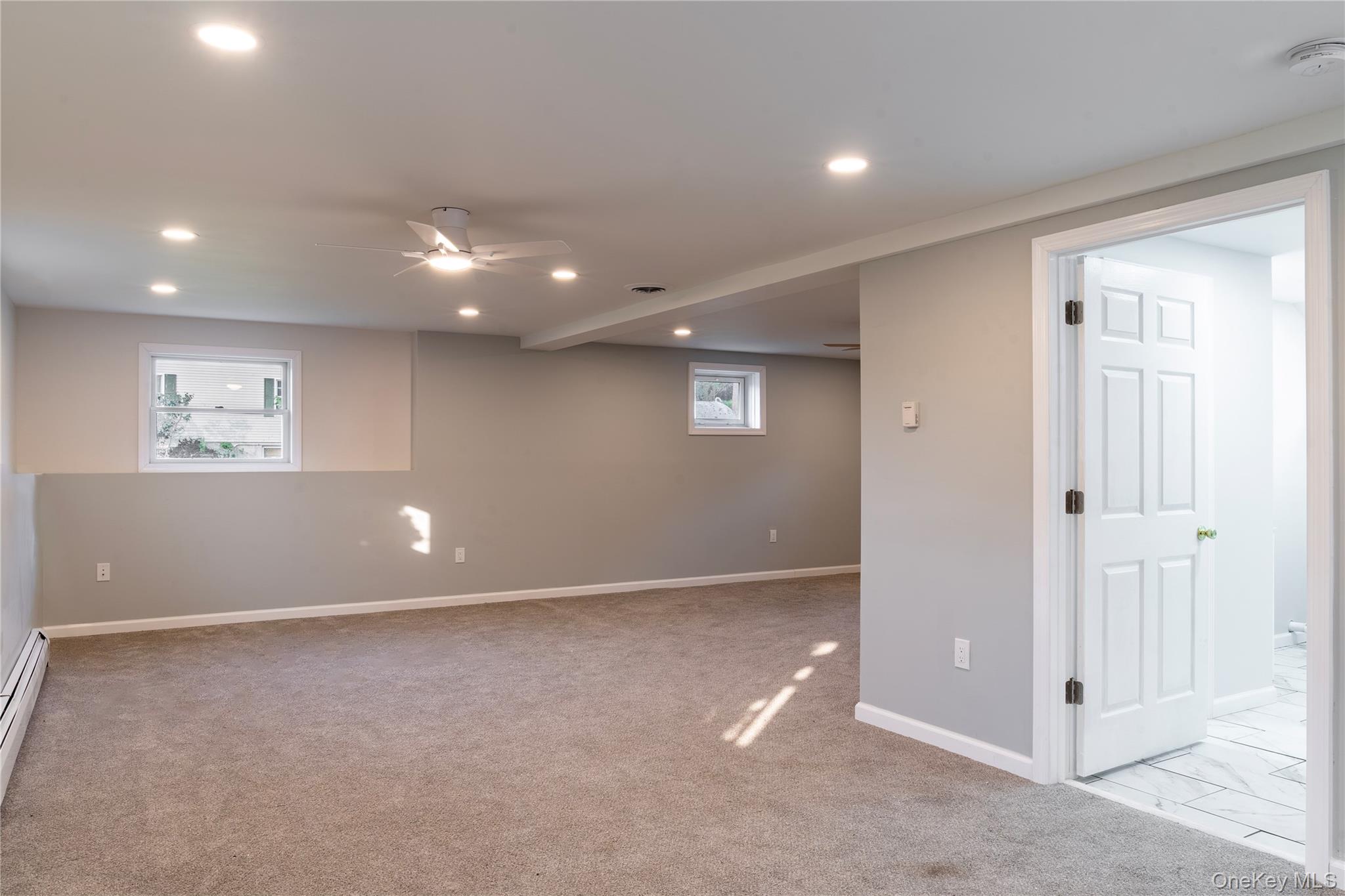 376 Wade Road Liberty, NY 12754 - Photo 17 of 26 Below grade area with recessed lighting, light carpet, ceiling fan, and a baseboard radiator