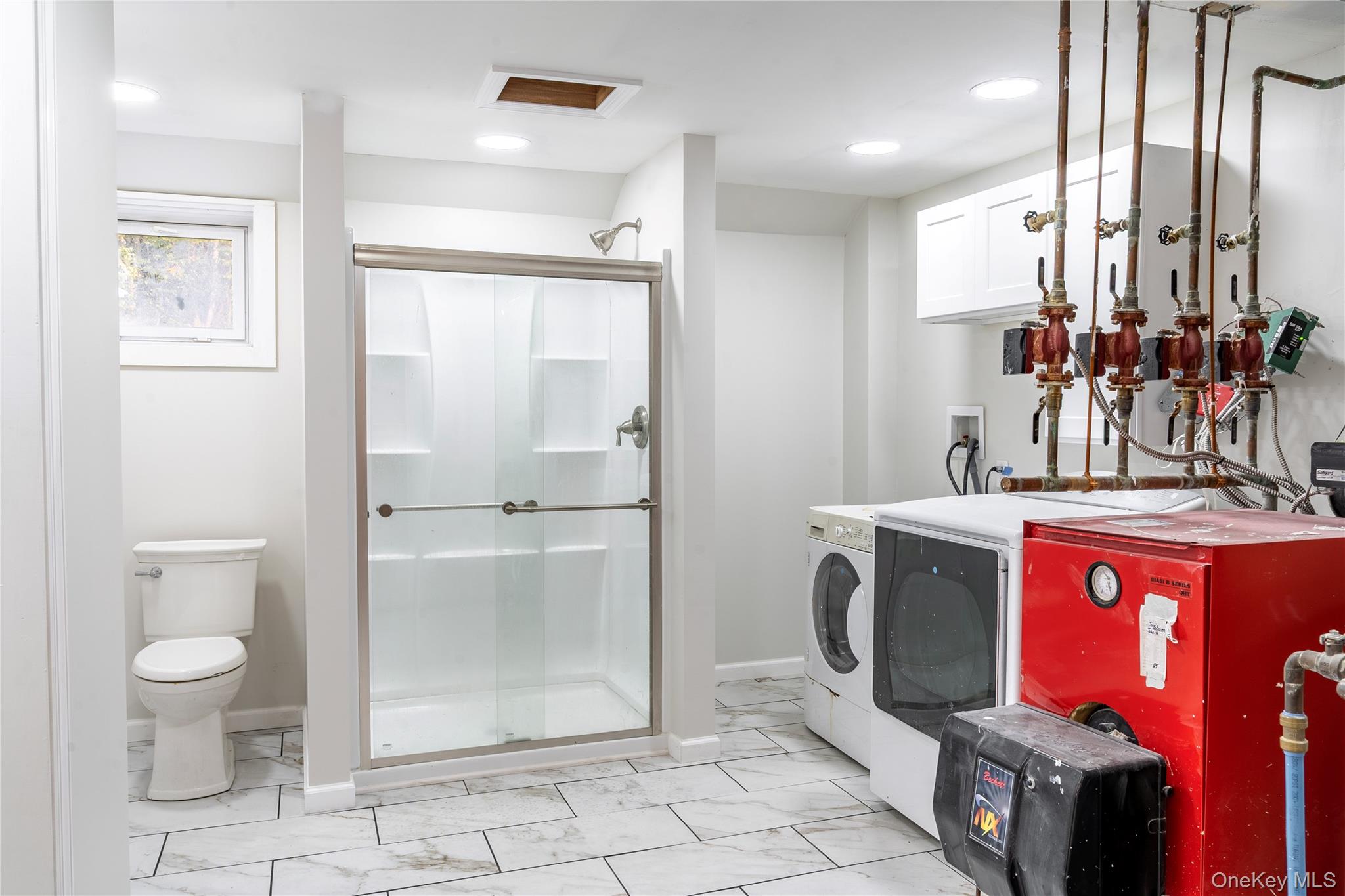 376 Wade Road Liberty, NY 12754 - Photo 20 of 26 Full bath featuring a stall shower, light marble finish flooring, a heating unit, washer and dryer, and recessed lighting