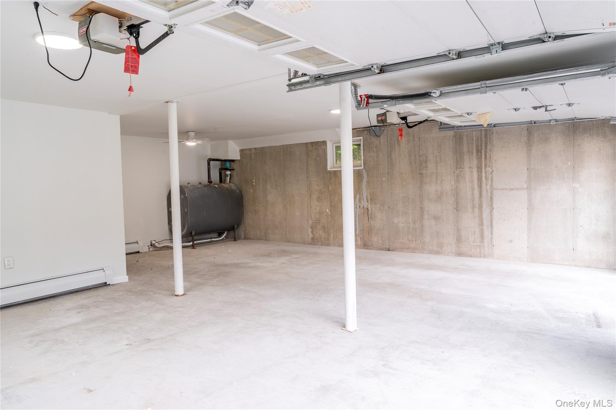 376 Wade Road Liberty, NY 12754 - Photo 23 of 26 Garage featuring oil tank and a garage door opener