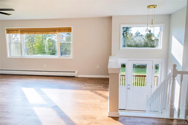 a view of entry way with wooden floor and a window