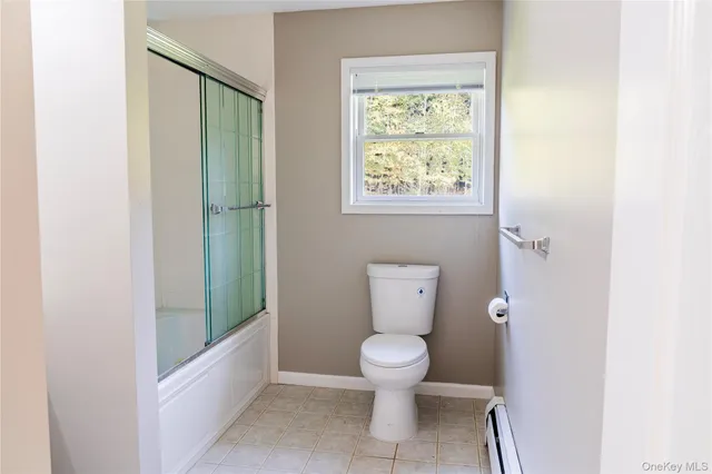 a white toilet sitting next to a bathroom sink