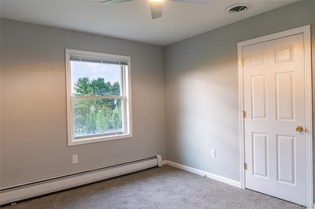an empty room with windows and closet