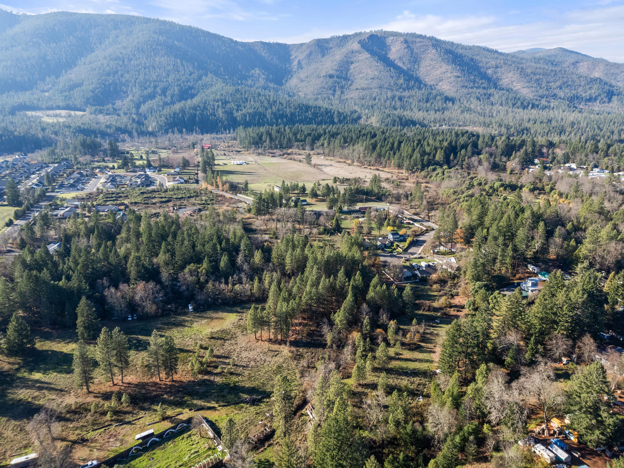 681 Daisy Hill Road Cave Junction, OR 97523 - Photo 7 of 26 a view of a town with mountains in the background