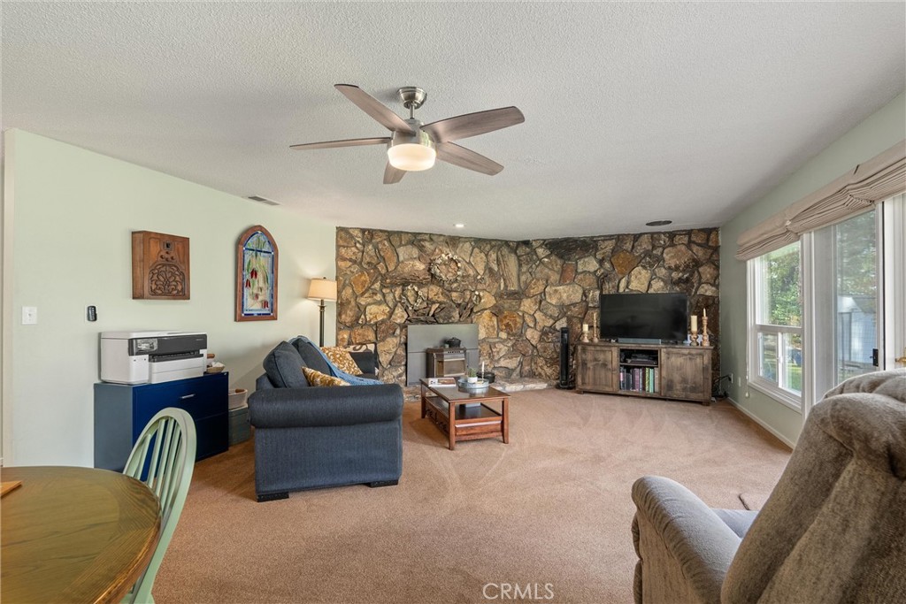16298 Forest Ranch Road Forest Ranch, CA 95942 - Photo 16 of 67 a living room with furniture a flat screen tv and a large window