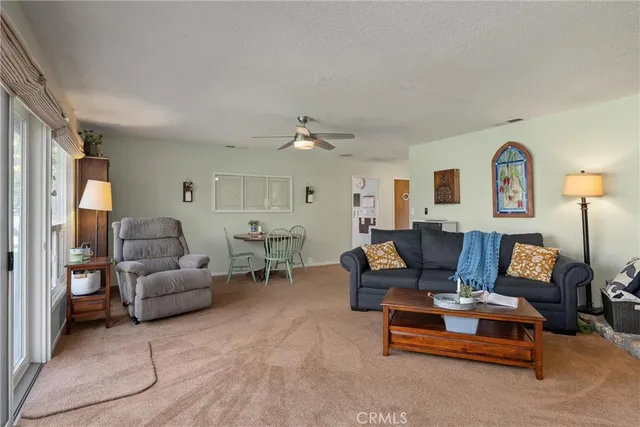 a kitchen with a refrigerator a stove and a dining table with wooden floor
