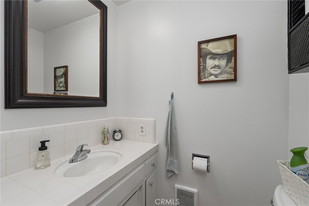 16298 Forest Ranch Road Forest Ranch, CA 95942 - Photo 28 of 67 a bathroom with a sink mirror and toilet