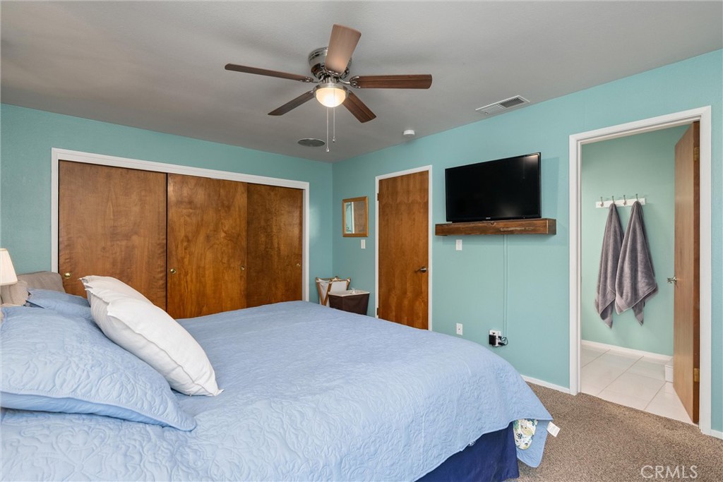 16298 Forest Ranch Road Forest Ranch, CA 95942 - Photo 39 of 67 a bedroom with a large bed and a flat screen tv