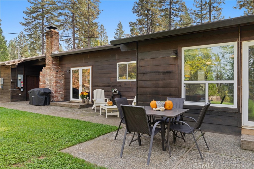 16298 Forest Ranch Road Forest Ranch, CA 95942 - Photo 59 of 67 a table and chairs in front of a house