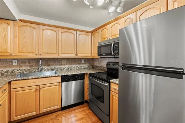 a kitchen with granite countertop a sink and cabinets