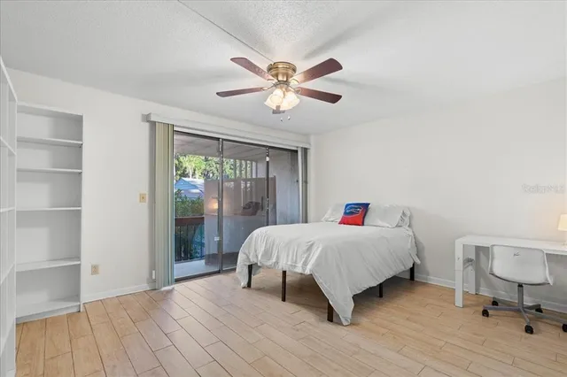 a bedroom with a large bed window and a chandelier