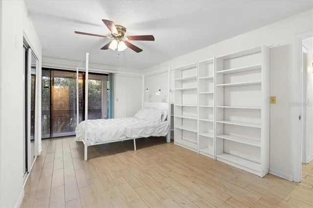 a bedroom with a large bed and chandelier