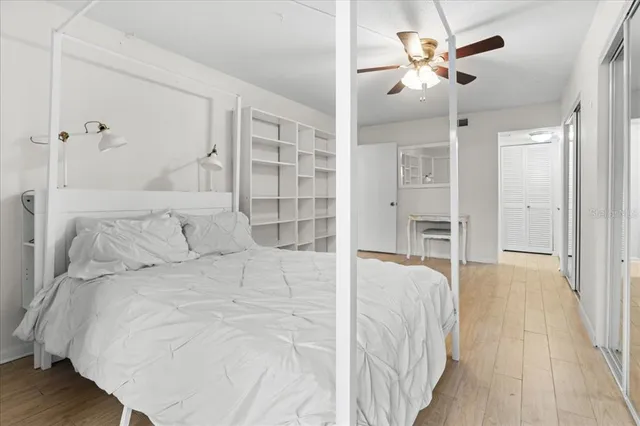 a bedroom with a bed and glass door