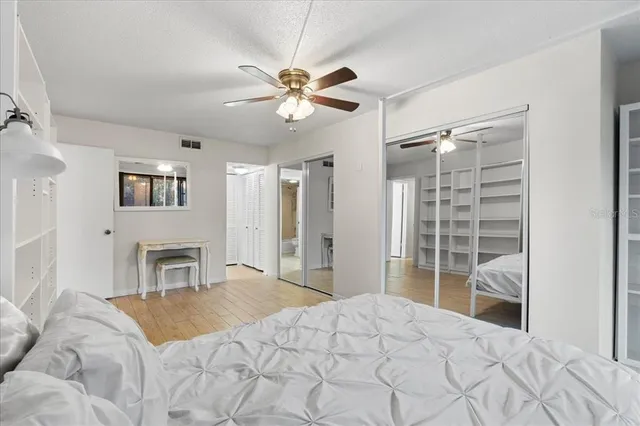 a bathroom with a granite countertop sink mirror vanity and toilet