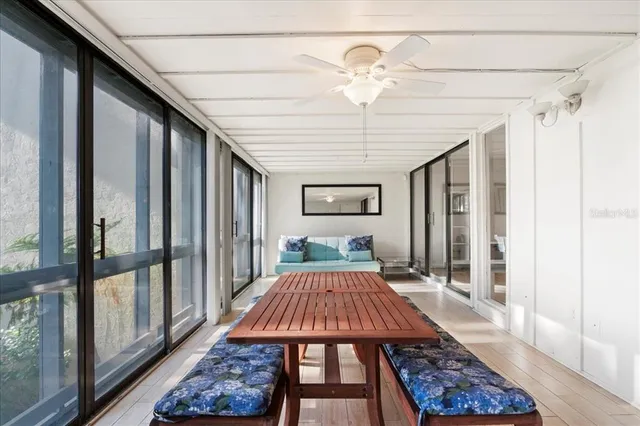 a balcony view with a lot of furniture and floor to ceiling window