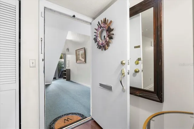 a view of a dining room with furniture a chandelier and wooden floor