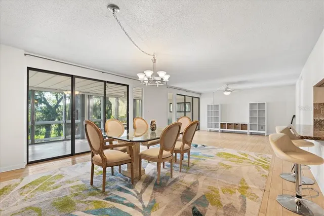 a view of a dining room with furniture and chandelier