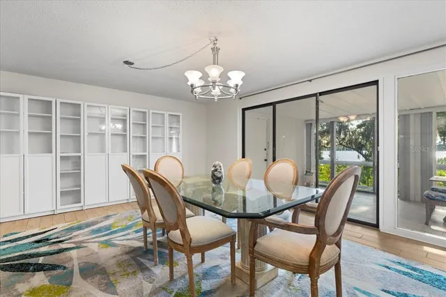 a view of a dining room with furniture wooden floor and chandelier