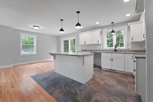 a kitchen with a sink window and cabinets