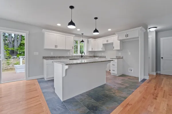 a kitchen with kitchen island a sink stainless steel appliances and cabinets