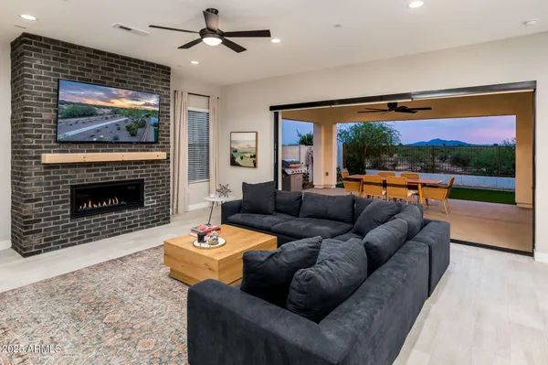 a living room with furniture a flat screen tv and a fireplace