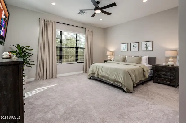 a bedroom with a large bed and a window