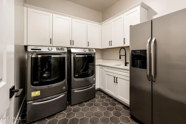 a kitchen with stainless steel appliances granite countertop a refrigerator and a stove