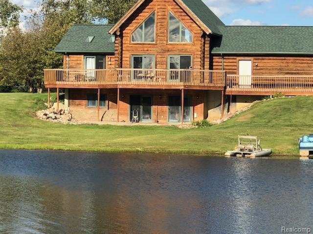 10374 Wilson Road Otisville, MI 48463 - Photo 4 of 99 Rear view of property featuring a yard, a deck with water view, and log siding