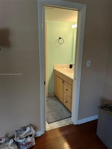 a bathroom with a sink a toilet a mirror and a shower