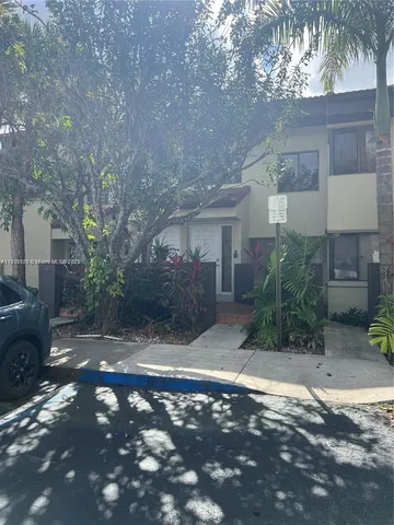 a view of yard in front of house with trees