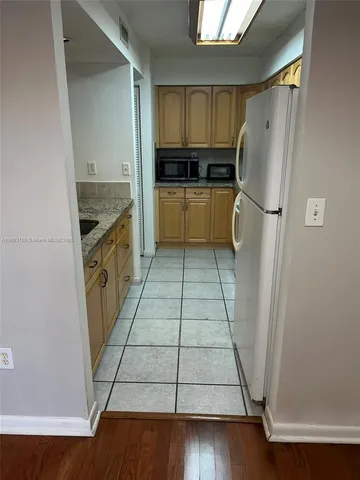 a kitchen with a stove a sink and a microwave