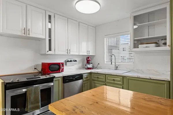 a kitchen with a sink stove and cabinets