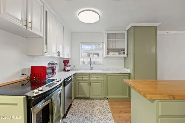 a kitchen with a sink stove and cabinets