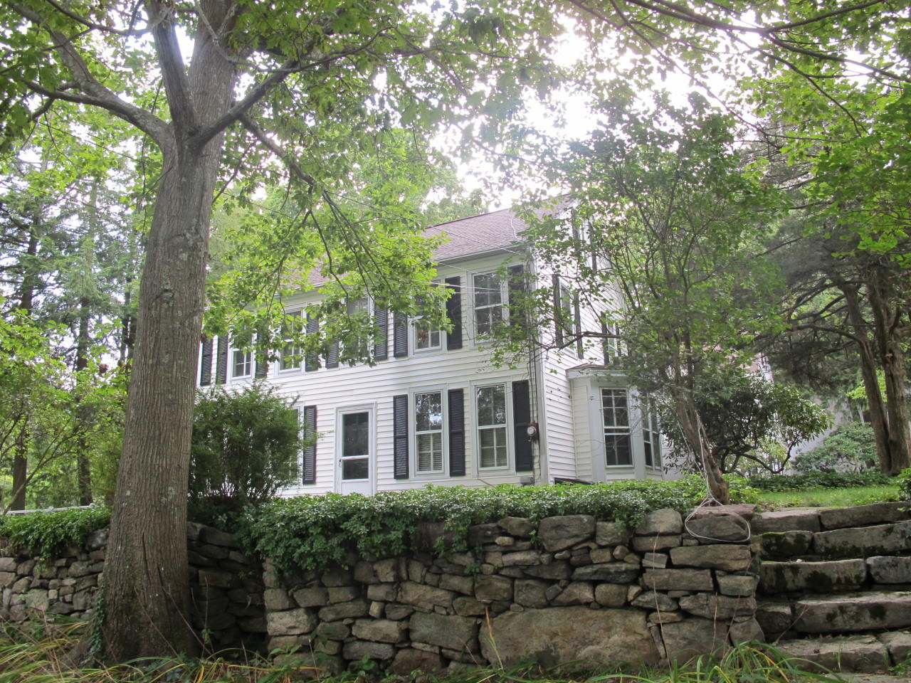 280 Rosebrook Road New Canaan, CT 06840 - Photo 1 of 12 a front view of a house with a garden