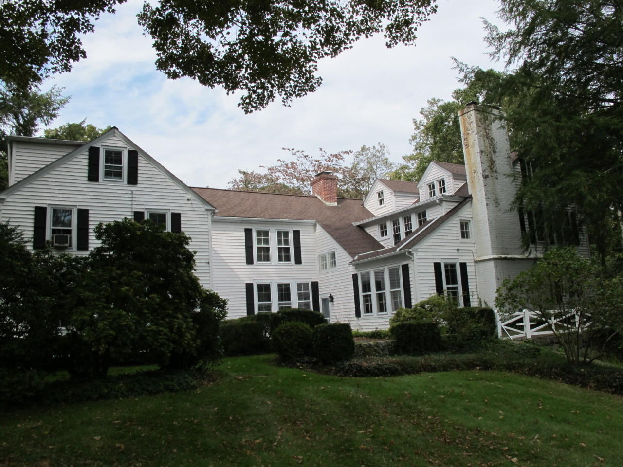 280 Rosebrook Road New Canaan, CT 06840 - Photo 2 of 12 a front view of a house with a garden