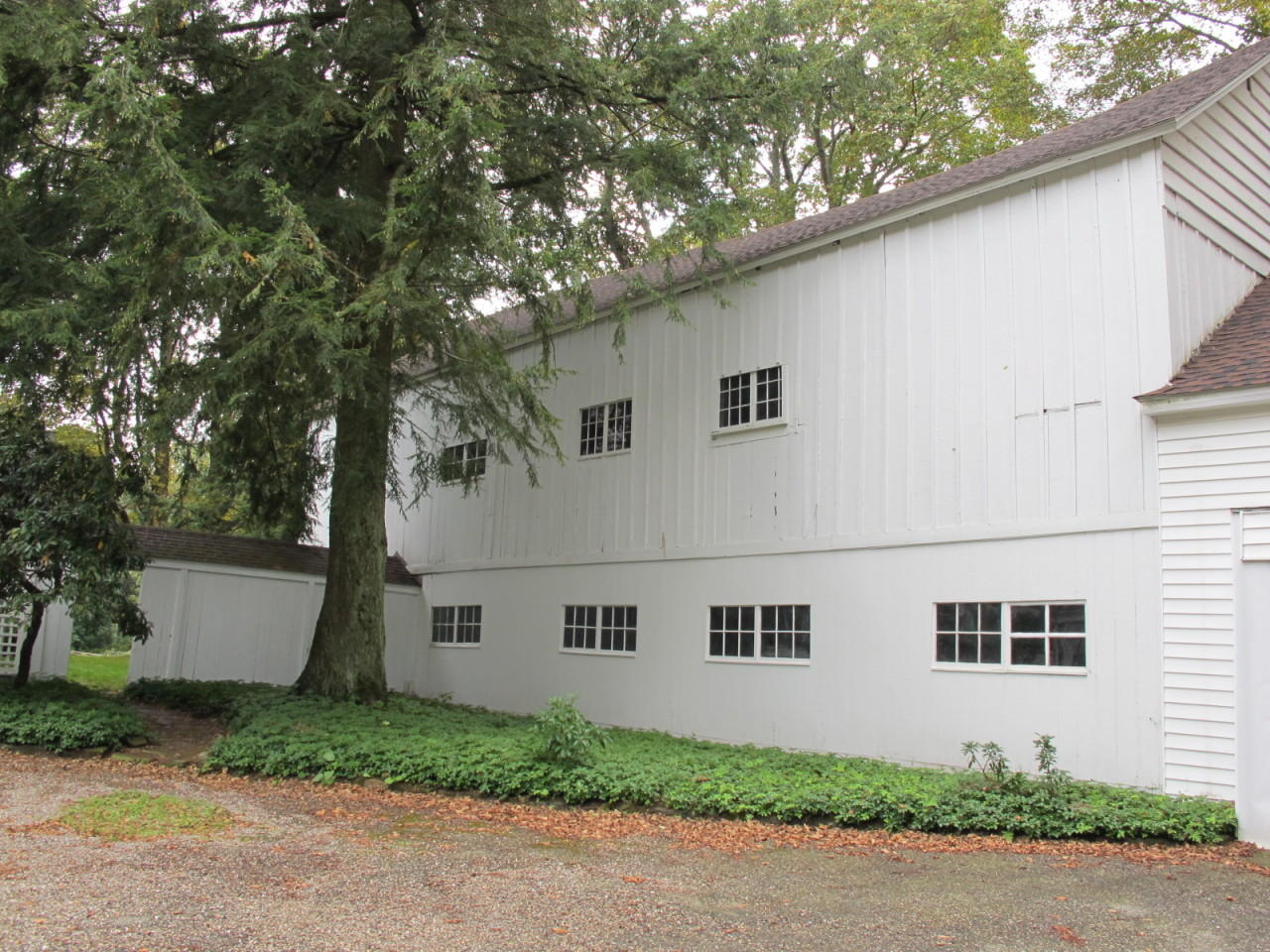 280 Rosebrook Road New Canaan, CT 06840 - Photo 4 of 12 a white house with trees in front of it