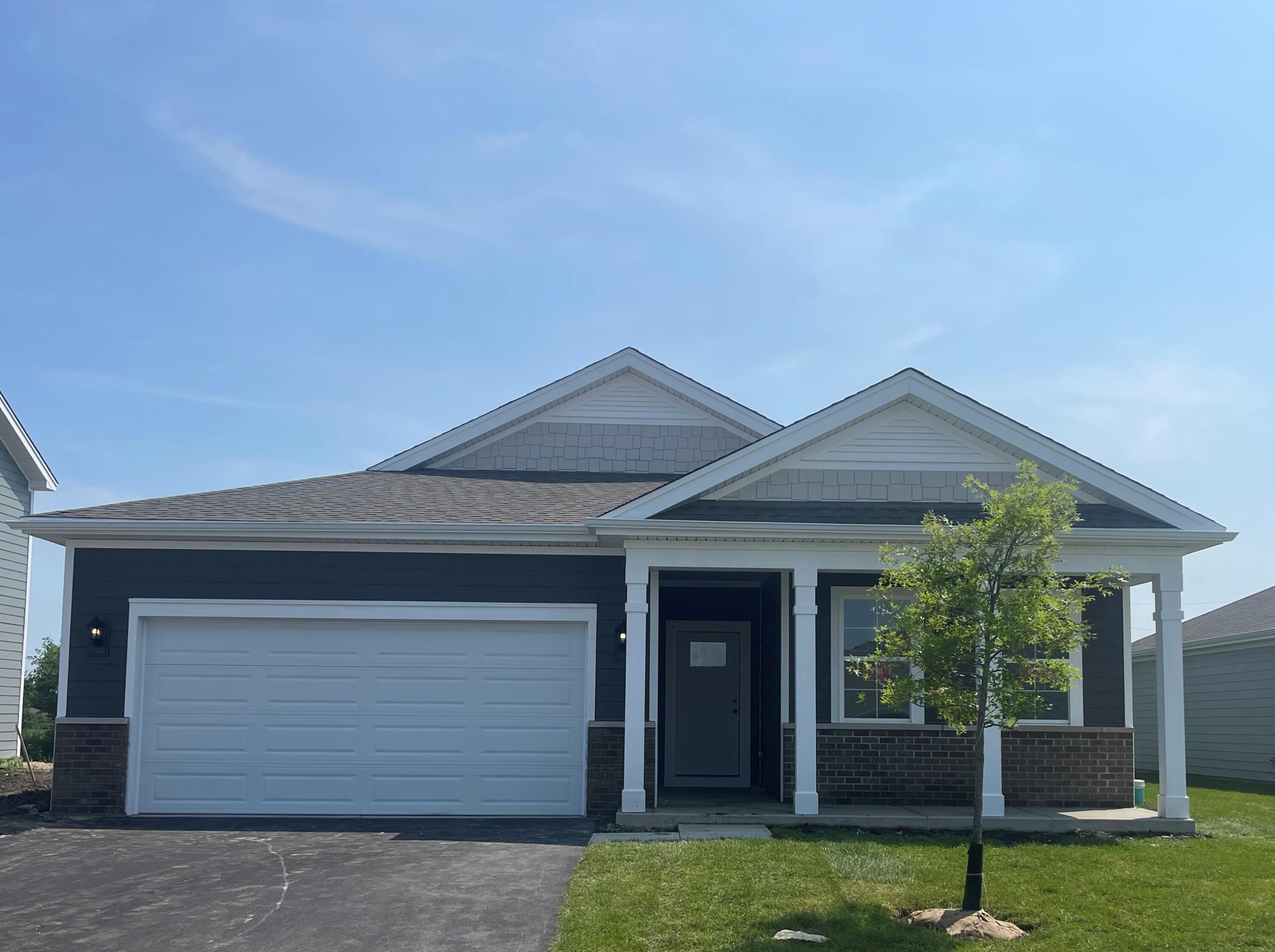7293 West 107th Place Crown Point, IN 46307 - Photo 1 of 24 a front view of a house with a yard and garage